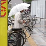 Image of a Japanese man I encountered while exiting the Tokyo subway train station. It was still early in the day and he was drinking some type of hard alcohol straight from the bottle. As the rain fell, from under his umbrella he stared blankly at the top of a nearby high rise tower. I got the distinct impression from the look on his face that he was completely burnt out, drained to the point of breaking. I tried to be respectful while capturing the picture which is why it's slightly out of focus. It was a strange greeting as I stepped out into the streets of Tokyo city.